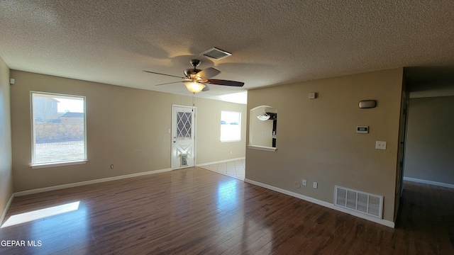 spare room with a textured ceiling, hardwood / wood-style flooring, and ceiling fan