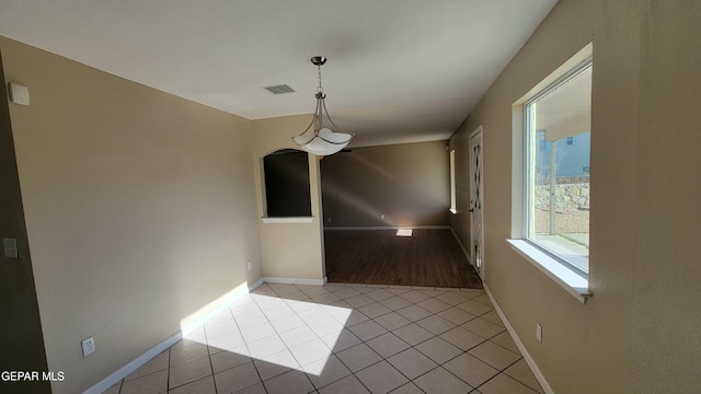 unfurnished dining area featuring light tile patterned floors