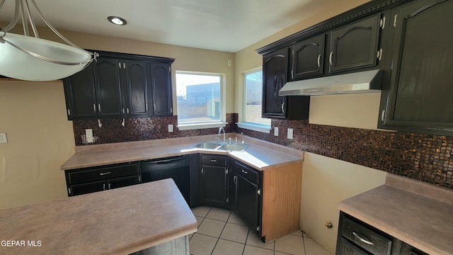 kitchen with backsplash, sink, light tile patterned floors, pendant lighting, and black dishwasher