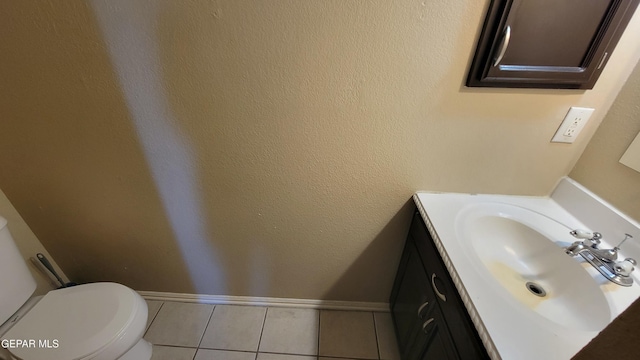 bathroom featuring tile patterned flooring, vanity, and toilet