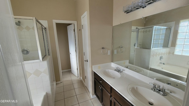 bathroom featuring plus walk in shower, vanity, and tile patterned floors