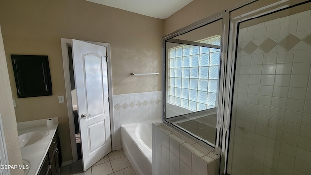 bathroom featuring tile patterned floors, a tub to relax in, and vanity