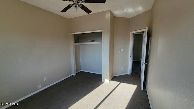 unfurnished bedroom featuring carpet, ceiling fan, a textured ceiling, and a closet