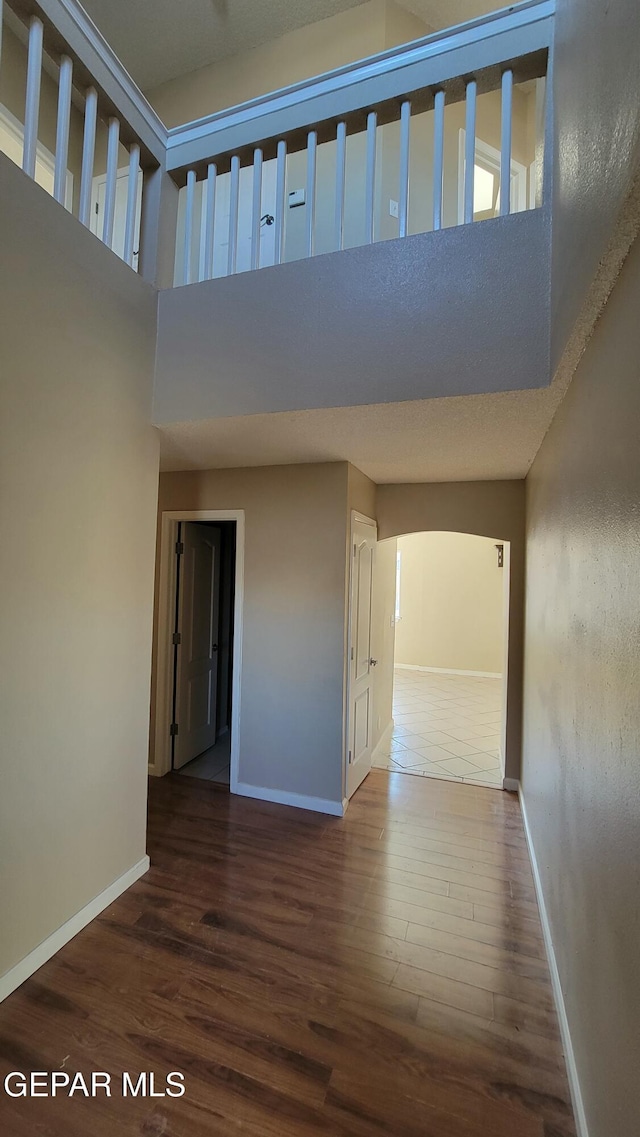 interior space featuring dark hardwood / wood-style flooring and a high ceiling