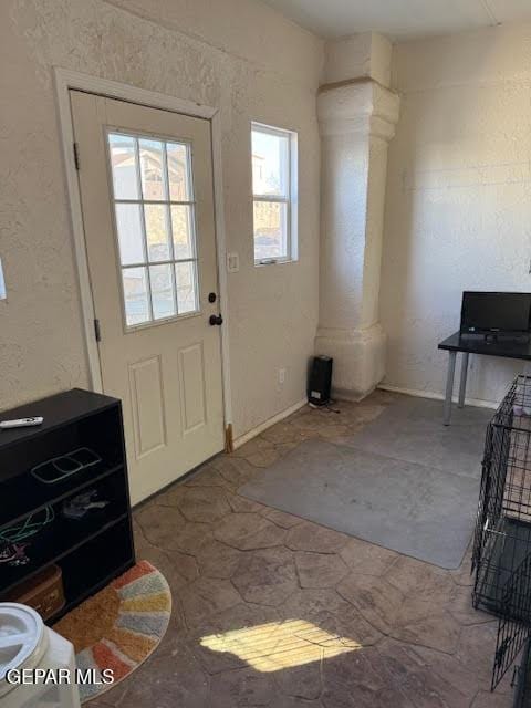 entryway featuring decorative columns