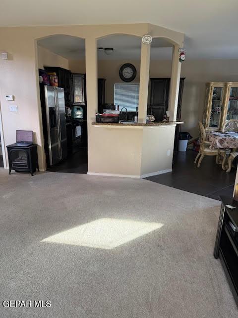 living area with dark carpet