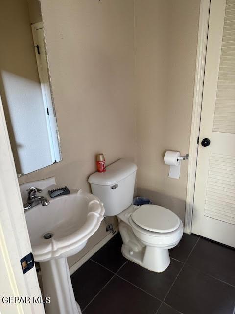 bathroom with tile patterned flooring and toilet