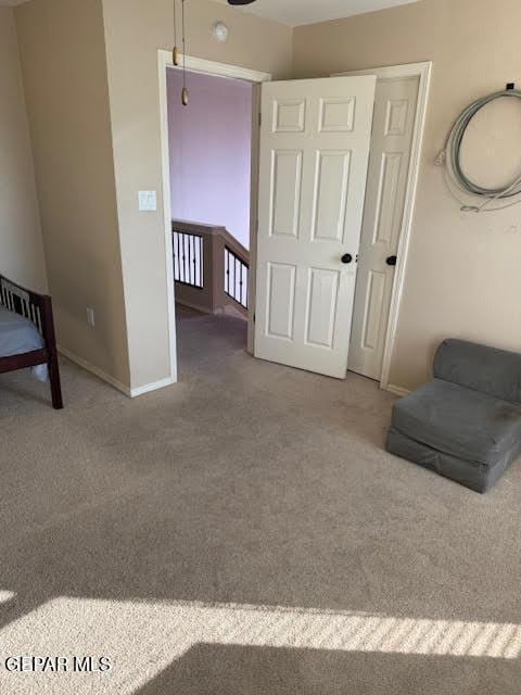 bedroom with baseboards and carpet flooring