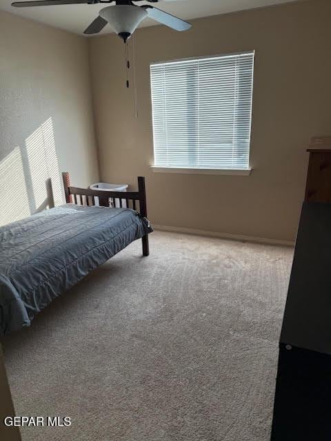 carpeted bedroom featuring a ceiling fan