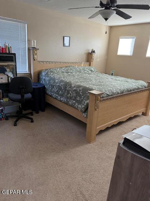 bedroom with carpet and a ceiling fan