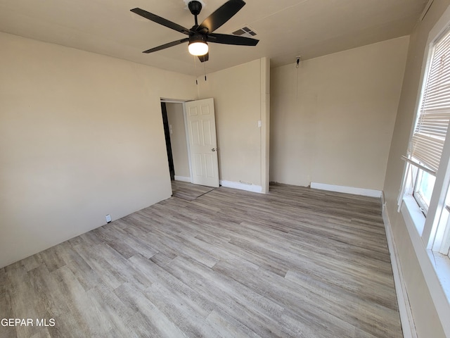 unfurnished room with ceiling fan and light hardwood / wood-style flooring