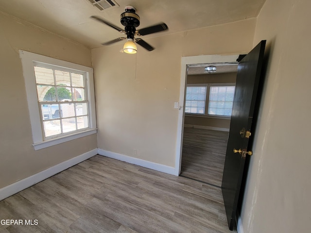 foyer with ceiling fan and light wood-type flooring