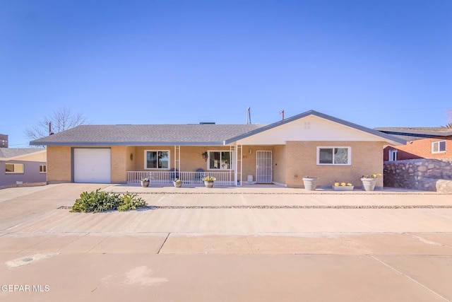 single story home featuring a porch and a garage