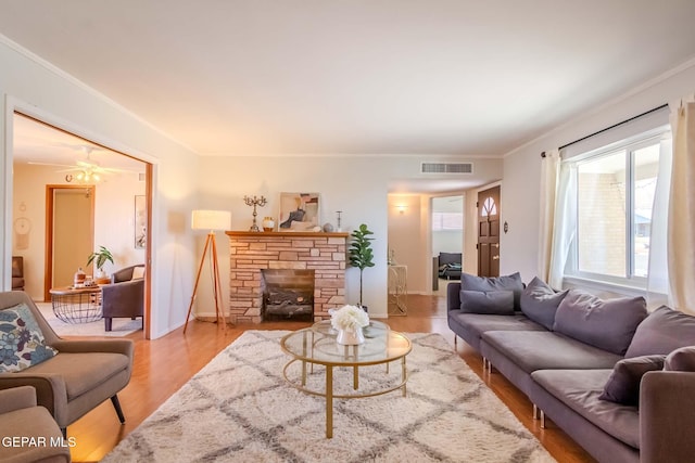 living room featuring light hardwood / wood-style flooring and ceiling fan