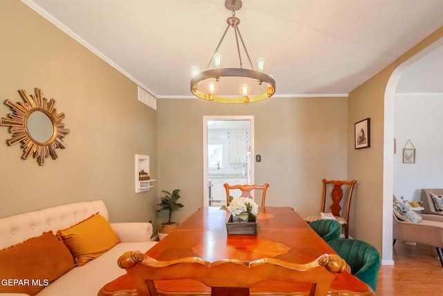 dining room with hardwood / wood-style flooring and ornamental molding