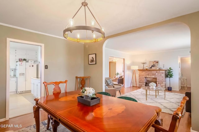 dining area featuring a fireplace and light hardwood / wood-style flooring