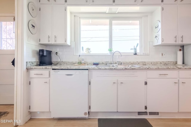 kitchen with white cabinets, white dishwasher, tasteful backsplash, and sink