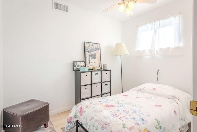 bedroom with light wood-type flooring and ceiling fan