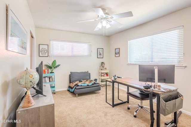 carpeted office featuring ceiling fan