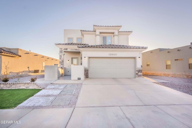 mediterranean / spanish-style home with a garage