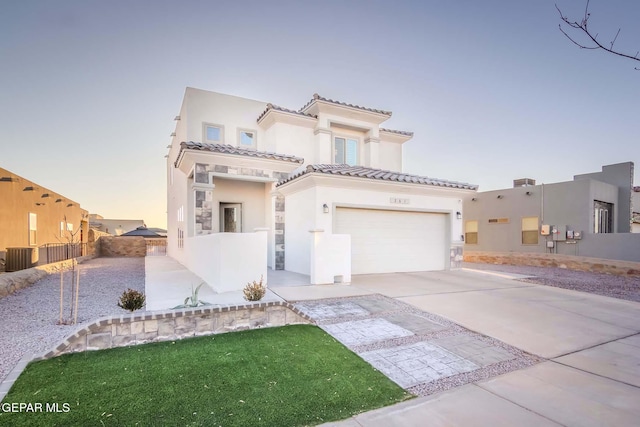 mediterranean / spanish home featuring a garage