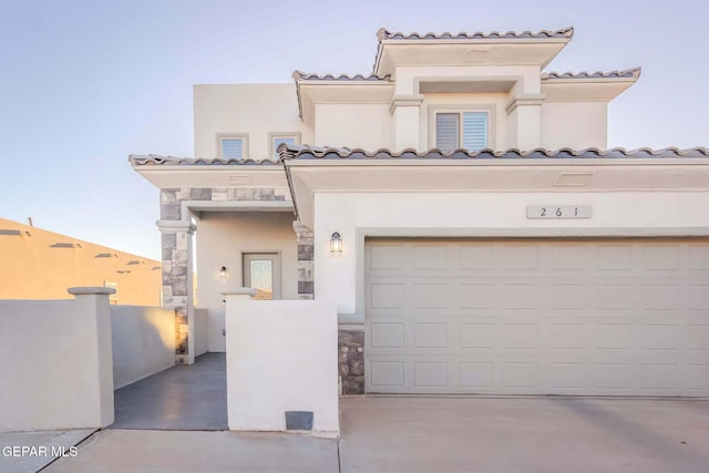 mediterranean / spanish-style house with a garage