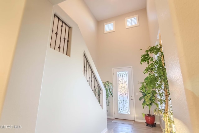 tiled entrance foyer featuring a high ceiling