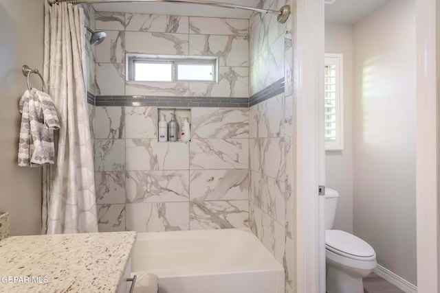 full bathroom featuring toilet, vanity, a wealth of natural light, and shower / bath combo with shower curtain