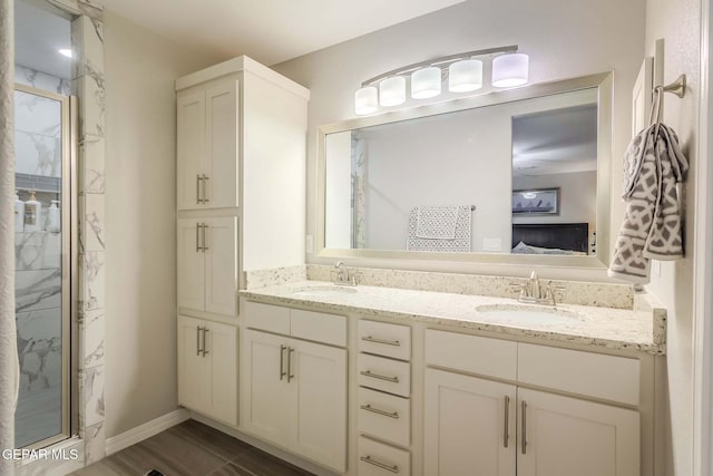 bathroom with vanity and a shower with shower door