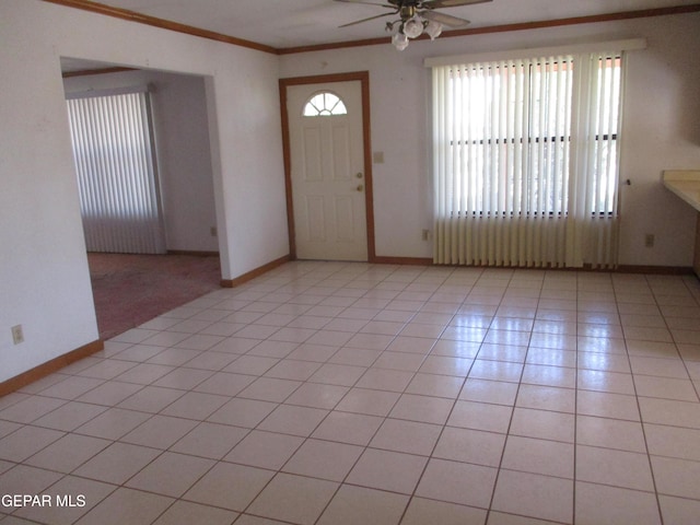 tiled foyer entrance with a wealth of natural light, ornamental molding, and ceiling fan