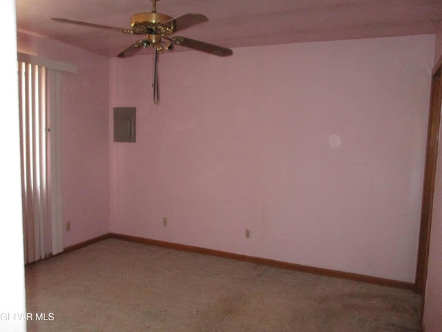 carpeted spare room with electric panel and ceiling fan