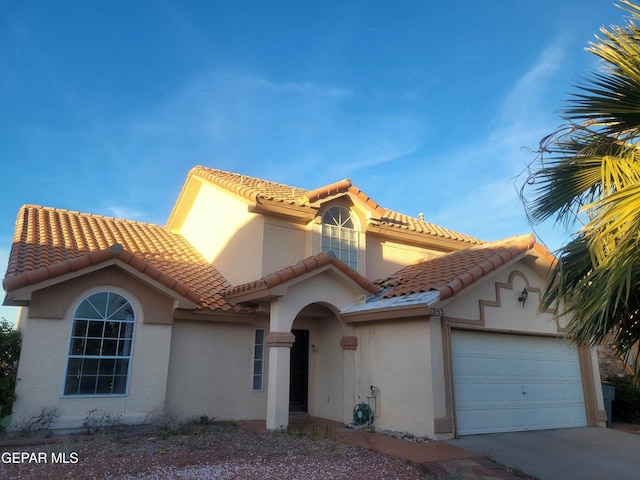 mediterranean / spanish-style home with a garage