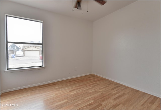 spare room with ceiling fan and light hardwood / wood-style flooring