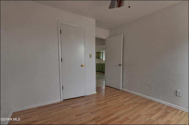 unfurnished room with ceiling fan and light wood-type flooring