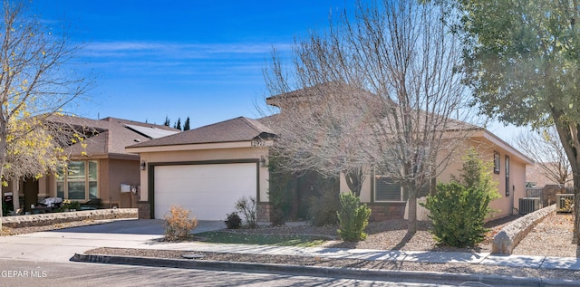 view of front of house with central AC and a garage