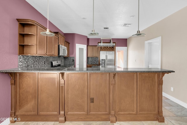 kitchen with backsplash, kitchen peninsula, stainless steel appliances, and decorative light fixtures