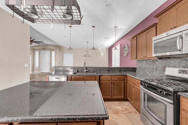 kitchen with ceiling fan, sink, hanging light fixtures, stainless steel appliances, and backsplash