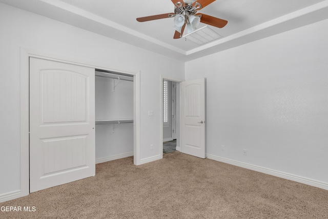 unfurnished bedroom featuring a closet, light colored carpet, and ceiling fan