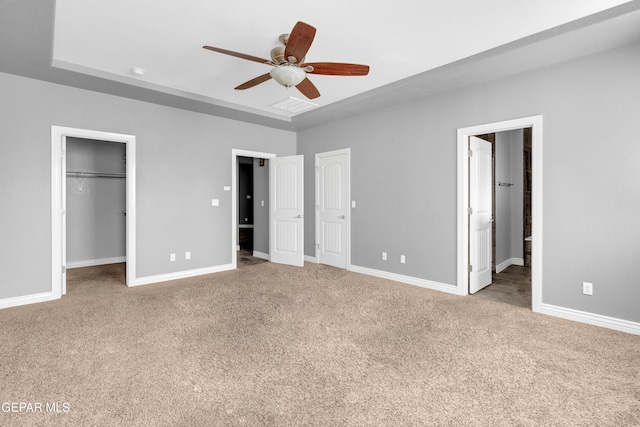 unfurnished bedroom featuring ceiling fan, carpet floors, and connected bathroom