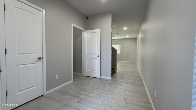 corridor with light wood-type flooring