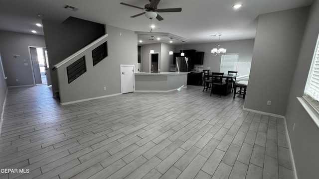 living room featuring ceiling fan with notable chandelier