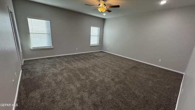 carpeted spare room with ceiling fan