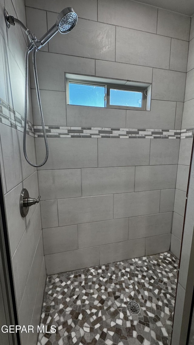 bathroom with tiled shower