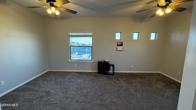 empty room with ceiling fan and dark carpet