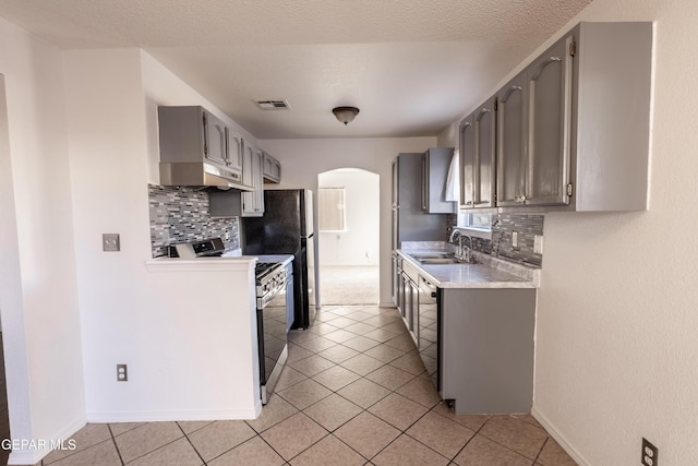 kitchen with gray cabinetry, black appliances, sink, decorative backsplash, and light tile patterned floors