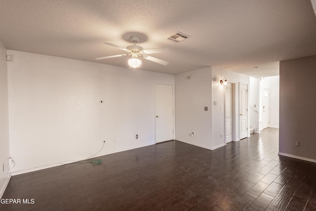 empty room featuring ceiling fan and a textured ceiling