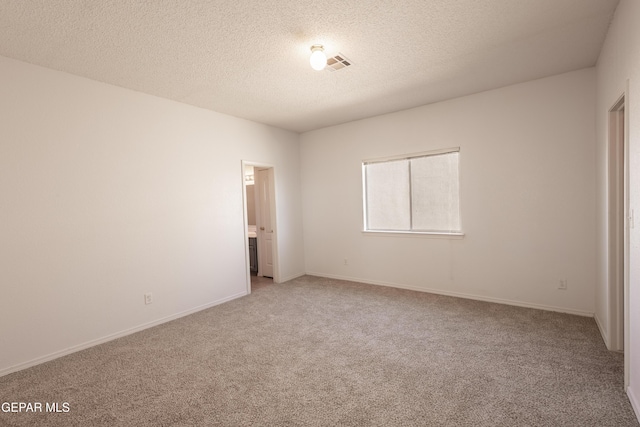 unfurnished bedroom featuring carpet flooring and a textured ceiling