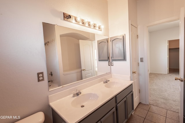 bathroom featuring tile patterned flooring, vanity, and toilet