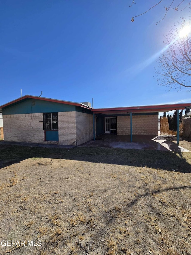 back of property with a patio