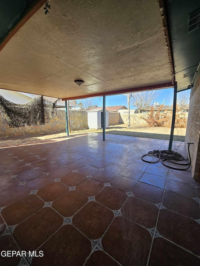 view of patio / terrace featuring a storage unit